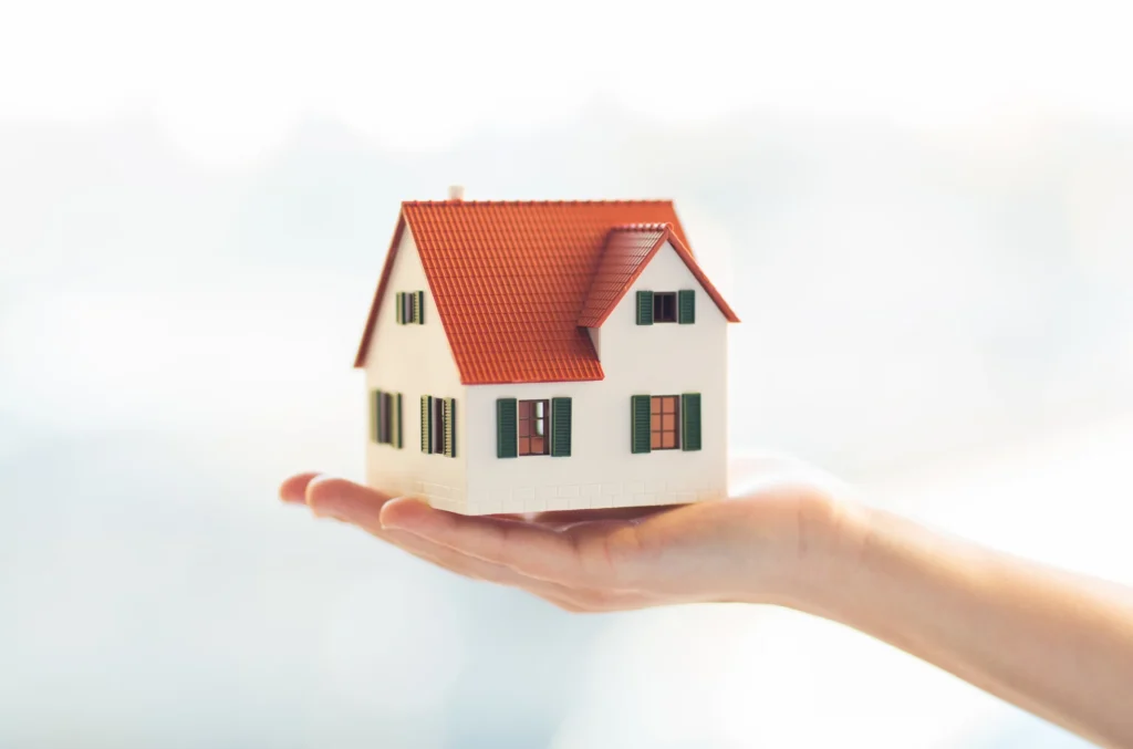 Hand holding model house real estate